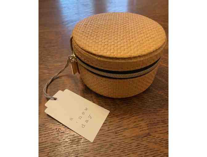 Small Round Jewelry Travel Organizer with necklace and earrings.