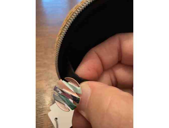 Small Round Jewelry Travel Organizer with necklace and earrings.