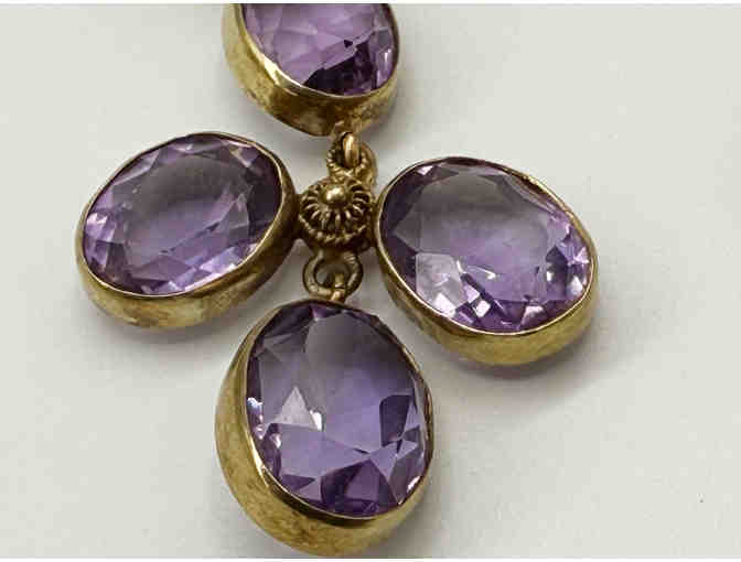 14K gold earrings set with faceted amethyst ovals